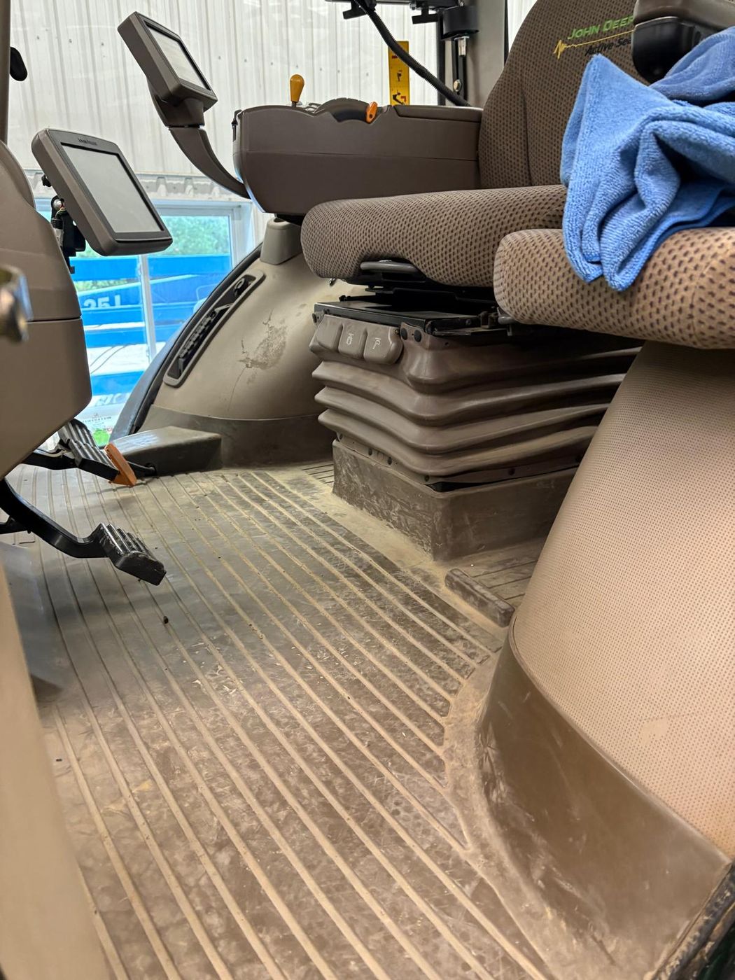 Tractor cab interior before detailing, dusty seats and floor