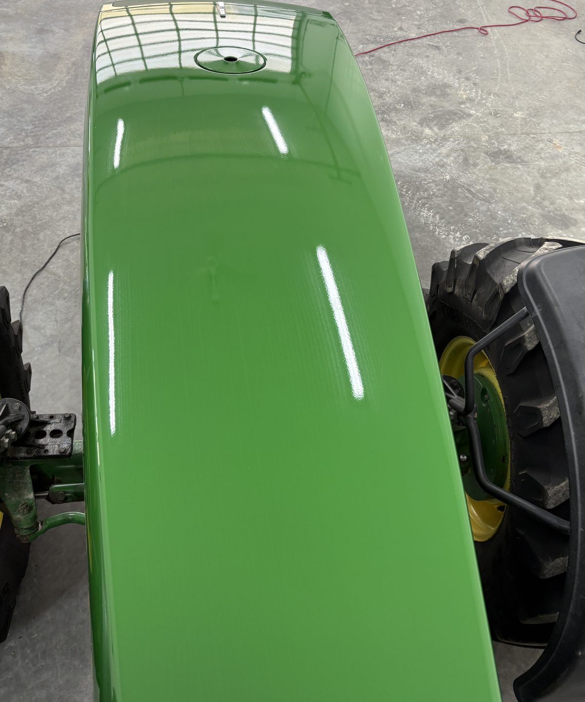 John Deere tractor hood after cut and polish, deep glossy green paint