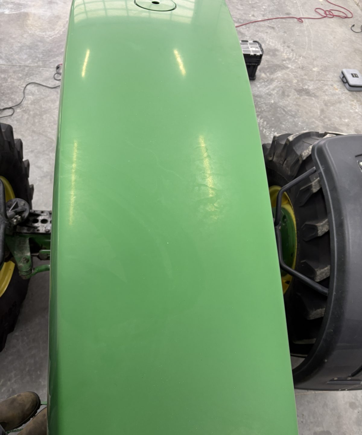 John Deere tractor hood before polishing, dull hazy green paint