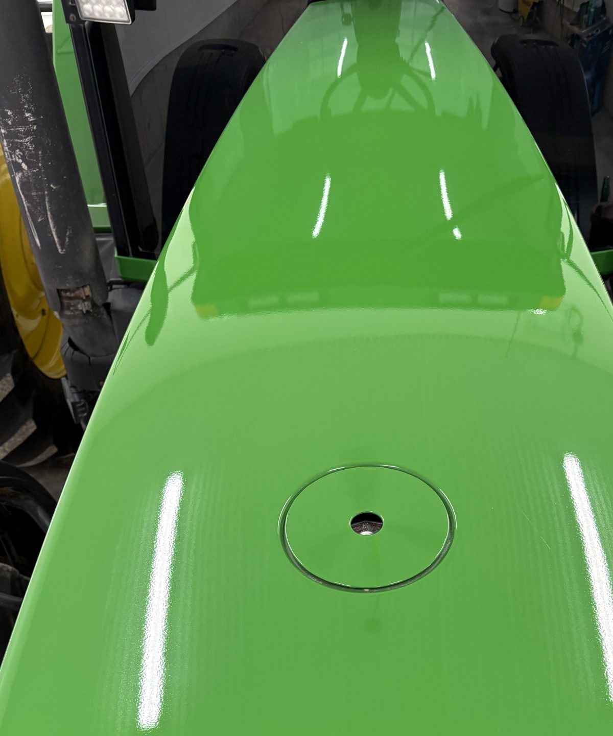 John Deere tractor hood panel after cut and polish, mirror gloss green paint